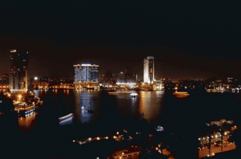 A Sunset Over A Body Of Water With A Building That Says ' Huawei ' On It GIF