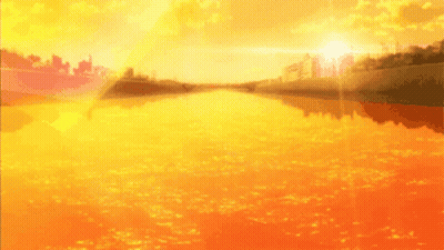 A Sunset Over A Body Of Water With A City In The Distance GIF