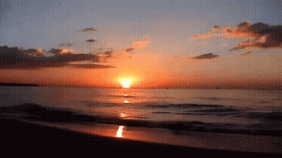 A Sunset Over A Body Of Water With The Sun Shining Brightly GIF