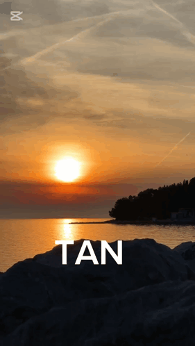 A Sunset Over A Body Of Water With The Word Tan GIF