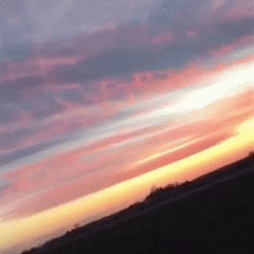 A Sunset With A Few Clouds In It GIF
