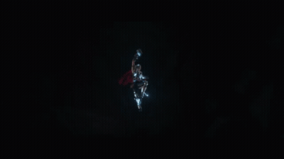 A Superhero With A Red Cape Is Being Struck By Lightning GIF