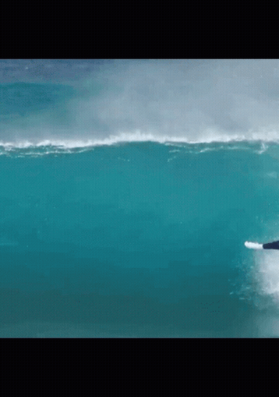 A Surfer Is Riding A Wave In The Ocean GIF