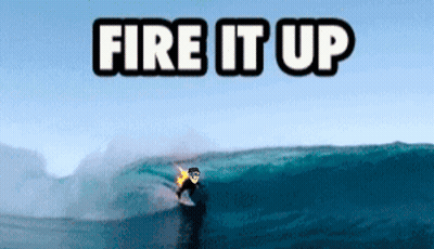 A Surfer Is Riding A Wave With The Words Fire It Up Above Him GIF