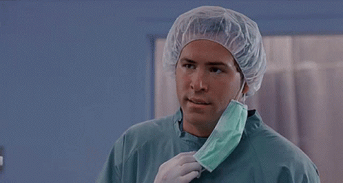 A Surgeon Is Wearing A Surgical Cap And Mask And Asking But Why . GIF