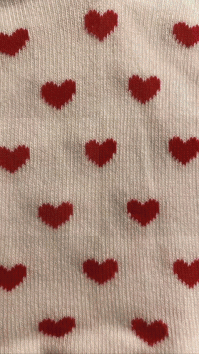 A Sweater With Red Hearts On It GIF