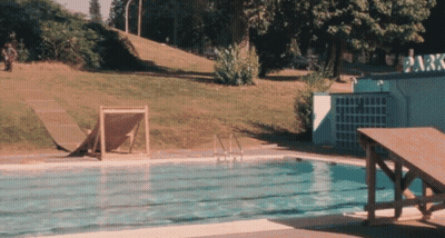 A Swimming Pool With A Sign That Says Park GIF