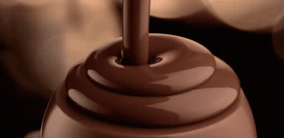 A Swirl Of Chocolate Is Being Poured Into A Container GIF