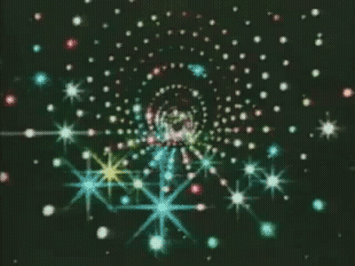 A Swirl Of Multicolored Stars On A Black Background GIF