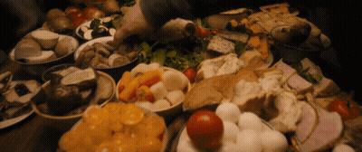 A Table Topped With Bowls Of Food Including Tomatoes And Bread GIF