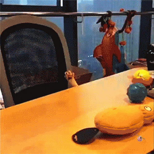 A Table With A Bunch Of Toys On It And A Chair GIF