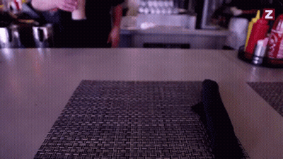 A Table With A Napkin On It And A Bottle Of Ketchup And Mustard With The Letter Z On It GIF