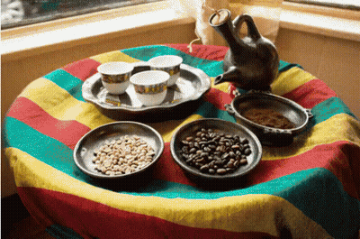 A Table With Bowls Of Coffee Beans And Cups Of Coffee GIF