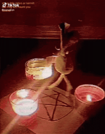 A Table With Candles And A Pentagram Drawn On It . GIF