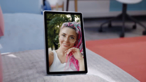 A Tablet Has A Picture Of A Woman With Pink Hair On It GIF