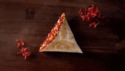 A Taco Bell Ad Shows A Grilled Stuff Nacho For 1.29 GIF