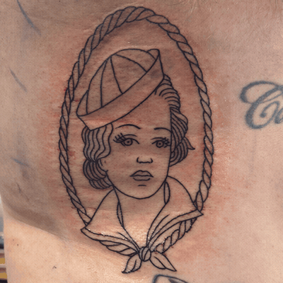 A Tattoo Of A Sailor With A Rope Around Her Neck GIF