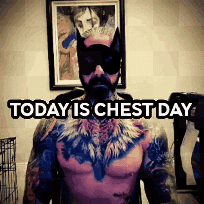 A Tattooed Man Wearing A Cat Mask And Sunglasses Says Today Is Chest Day GIF