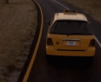 A Taxi Is Driving Down A Road With A City In The Background GIF