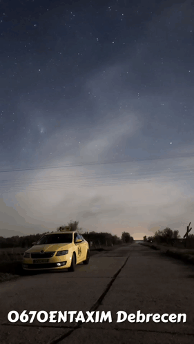 A Taxi Is Parked On The Side Of The Road Under A Starry Sky GIF