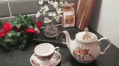 A Teapot Sits On A Table Next To A Cup And Saucer And A Book Titled English GIF
