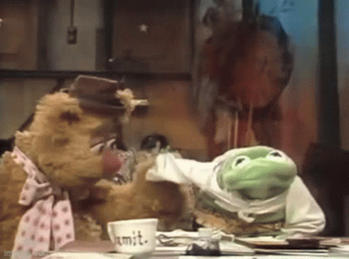A Teddy Bear And A Frog Are Sitting At A Table With A Cup That Says Mit . GIF