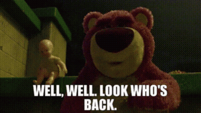 A Teddy Bear From Toy Story Is Standing Next To A Baby Doll And Says Well Well Look Who 'S Back GIF