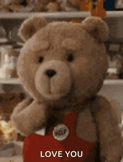 A Teddy Bear Is Holding A Heart And Saying `` I Love You '' . GIF