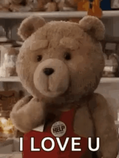A Teddy Bear Is Holding A Red Heart And Saying `` I Love You '' . GIF