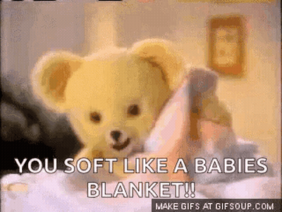A Teddy Bear Is Laying On A Bed With The Words You Soft Like A Babies Blanket GIF