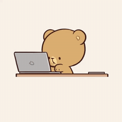 A Teddy Bear Is Laying On A Pillow Looking At A Cell Phone . GIF