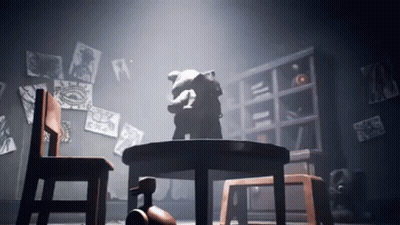 A Teddy Bear Is Sitting At A Table In A Dark Room GIF