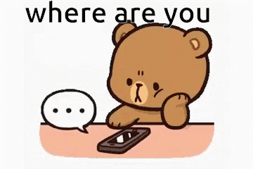 A Teddy Bear Is Sitting At A Table Looking At A Cell Phone And A Speech Bubble . GIF