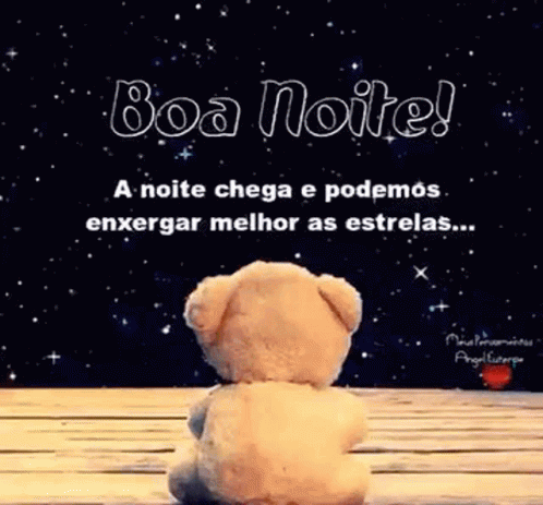 A Teddy Bear Is Sitting On A Wooden Table In Front Of A Starry Sky . GIF