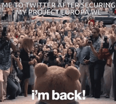 A Teddy Bear Is Standing In Front Of A Crowd Of People And Says " I 'M Back " GIF