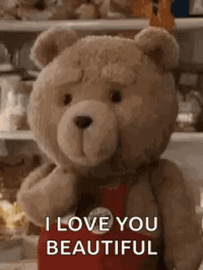 A Teddy Bear Is Standing Next To A Shelf And Says `` I Love You Beautiful '' . GIF
