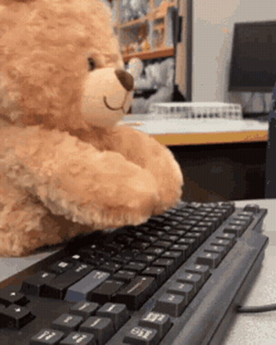 A Teddy Bear Is Typing On A Keyboard With The Shift Key On The Right Side GIF
