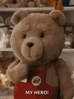 A Teddy Bear Is Wearing A Red Apron And Holding A Help Button . GIF