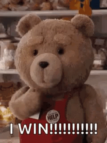 A Teddy Bear Is Wearing A Red Apron And Saying `` I Win !!! '' . GIF