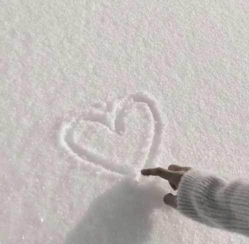 a teddy bear made out of snow is sitting on the ground