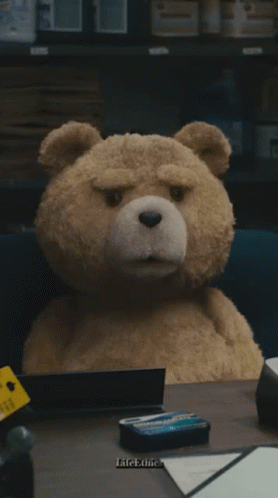 A Teddy Bear Sits At A Desk With The Words You Got A Lot Of Problems GIF