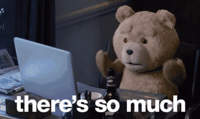 A Teddy Bear Sitting In Front Of A Laptop With The Words " There 'S So Much " Written Below It GIF