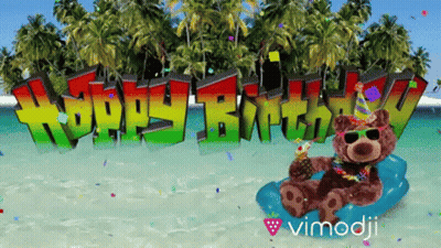 A Teddy Bear Sitting On A Beach With The Words Happy Birthday Behind Him GIF
