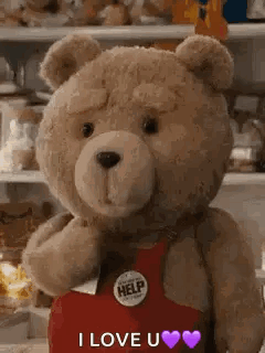 A Teddy Bear Wearing A Red Apron Is Standing In Front Of A Shelf And Says `` I Love You '' . GIF