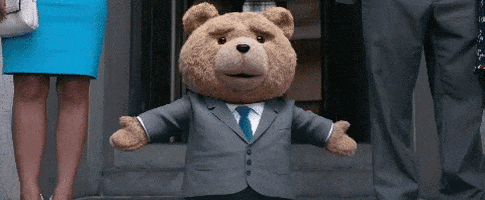 A Teddy Bear Wearing A Suit And Tie Is Standing In Front Of A Woman In A Blue Skirt GIF