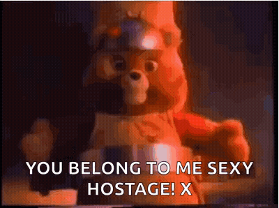 A Teddy Bear With A Helmet On Says `` You Belong To Me Sexy Hostage ! X '' GIF