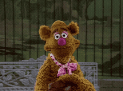 A Teddy Bear With A Pink Nose And Tie GIF