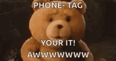 A Teddy Bear With The Words Phone Tag Your It Written On It GIF