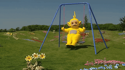 A Teletubbies Character Is Sitting On A Swing In The Grass GIF