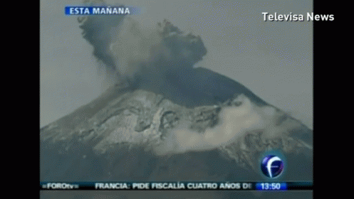 A Television Screen Shows A Volcano Erupting And Says Televisa News At The Top GIF